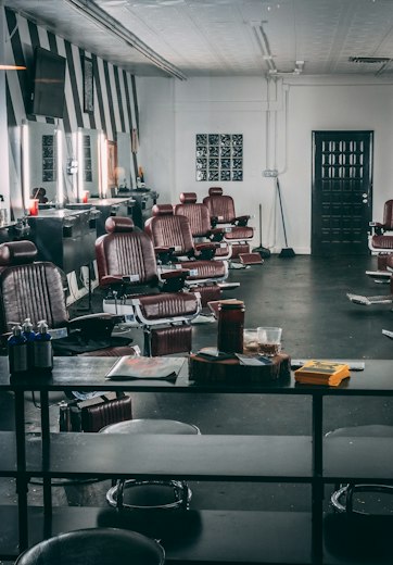 Row of leather barber chairs in a barbershop