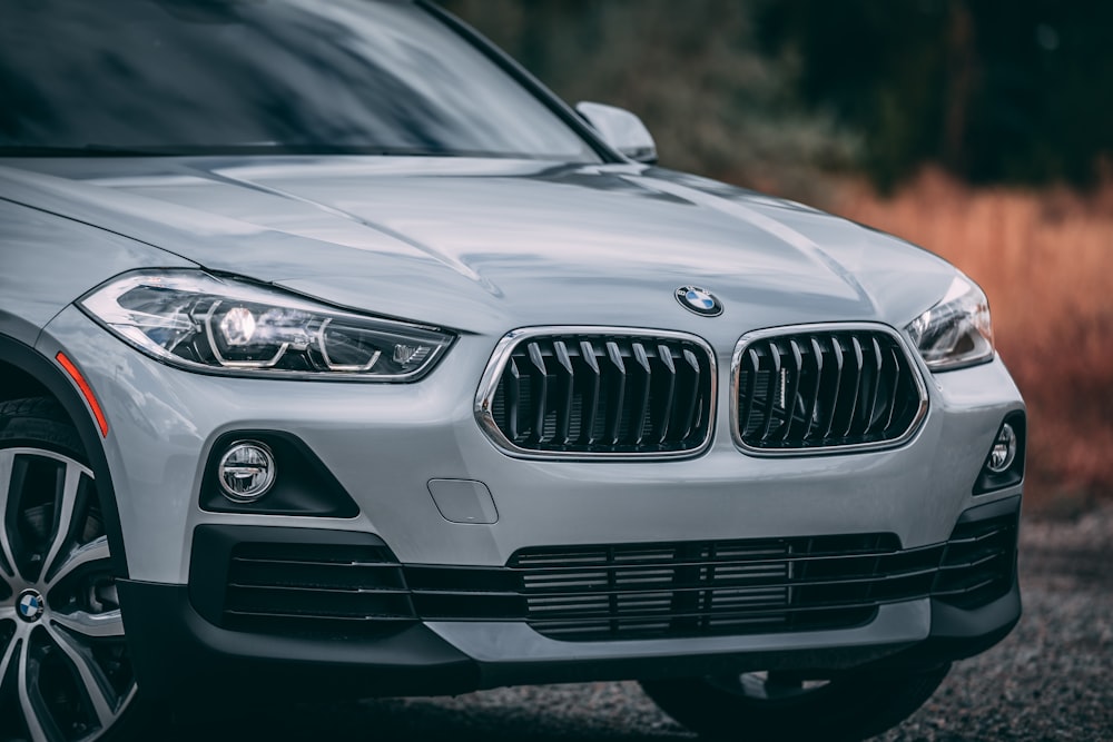 silver BMW X1 parking near road