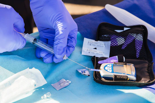 Close-up of hands preparing drug testing kits with royal blue and grey accents.