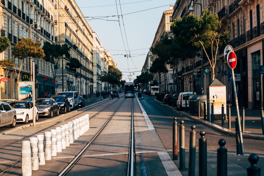 grey tram between buildings