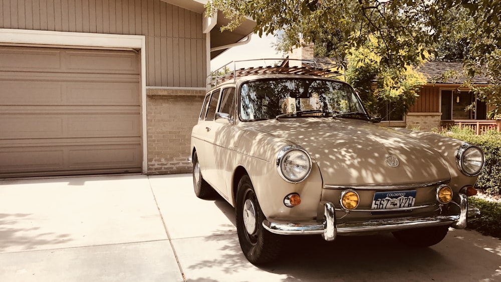 brown sedan parked in front of house