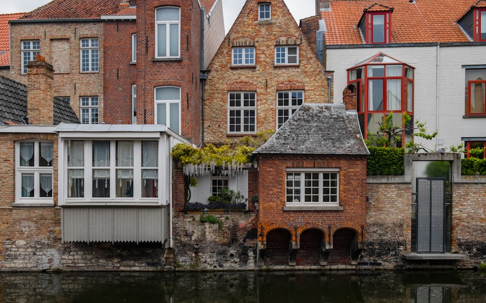 brown and white concrete houses near river