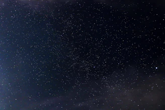 A serene cosmic landscape with swirling galaxies and bright stars illuminating the vastness of space.