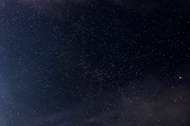 A serene cosmic landscape with swirling galaxies and bright stars illuminating the vastness of space.