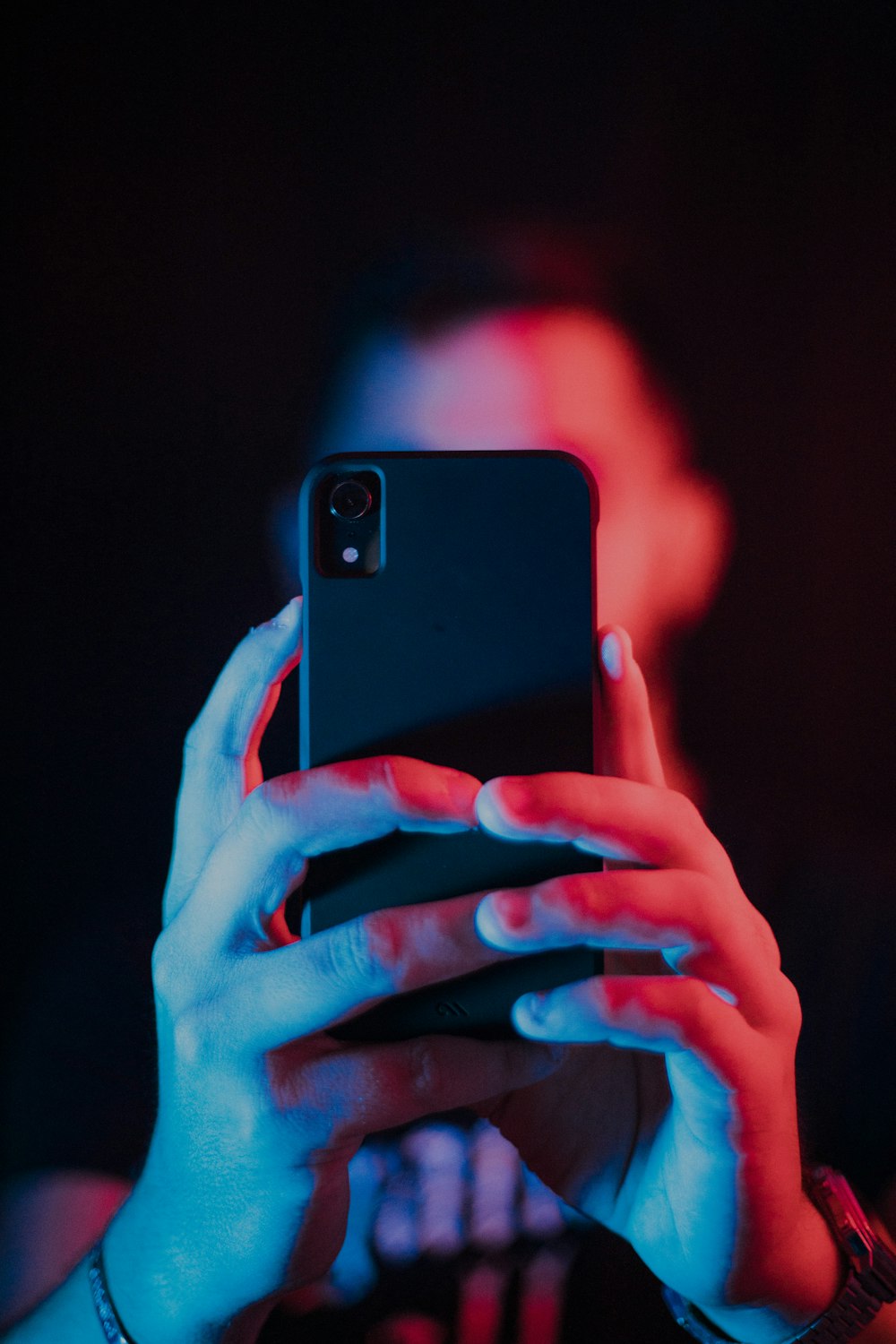 man holding black Android smartphone