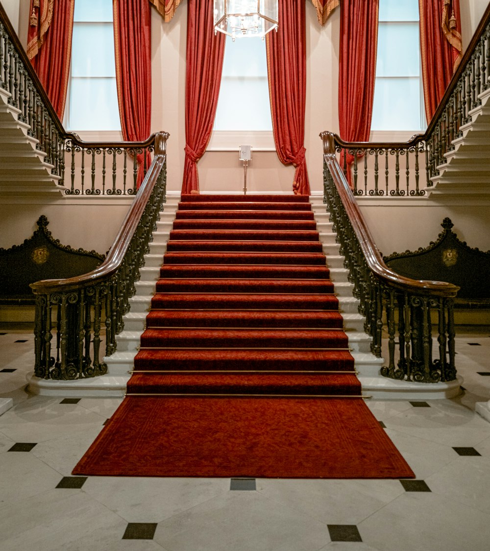 inside building with red carpet on stairs