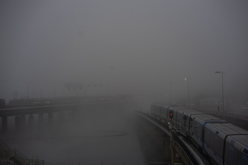 a train traveling on a foggy train track