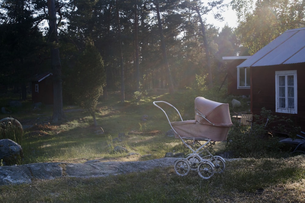 brown stroller near house