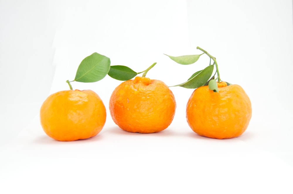 three orange fruits