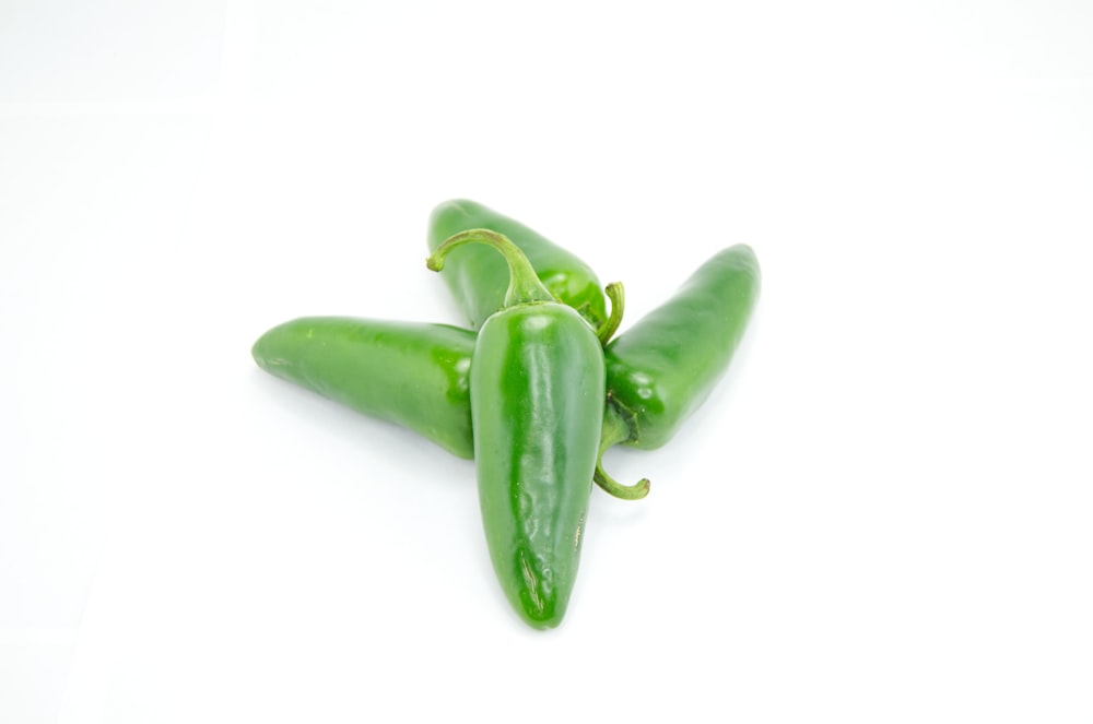 four green chili peppers