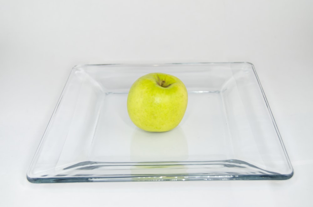 green apple on square clear glass tray