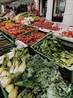 different vegetables on display and women standing near vegetable