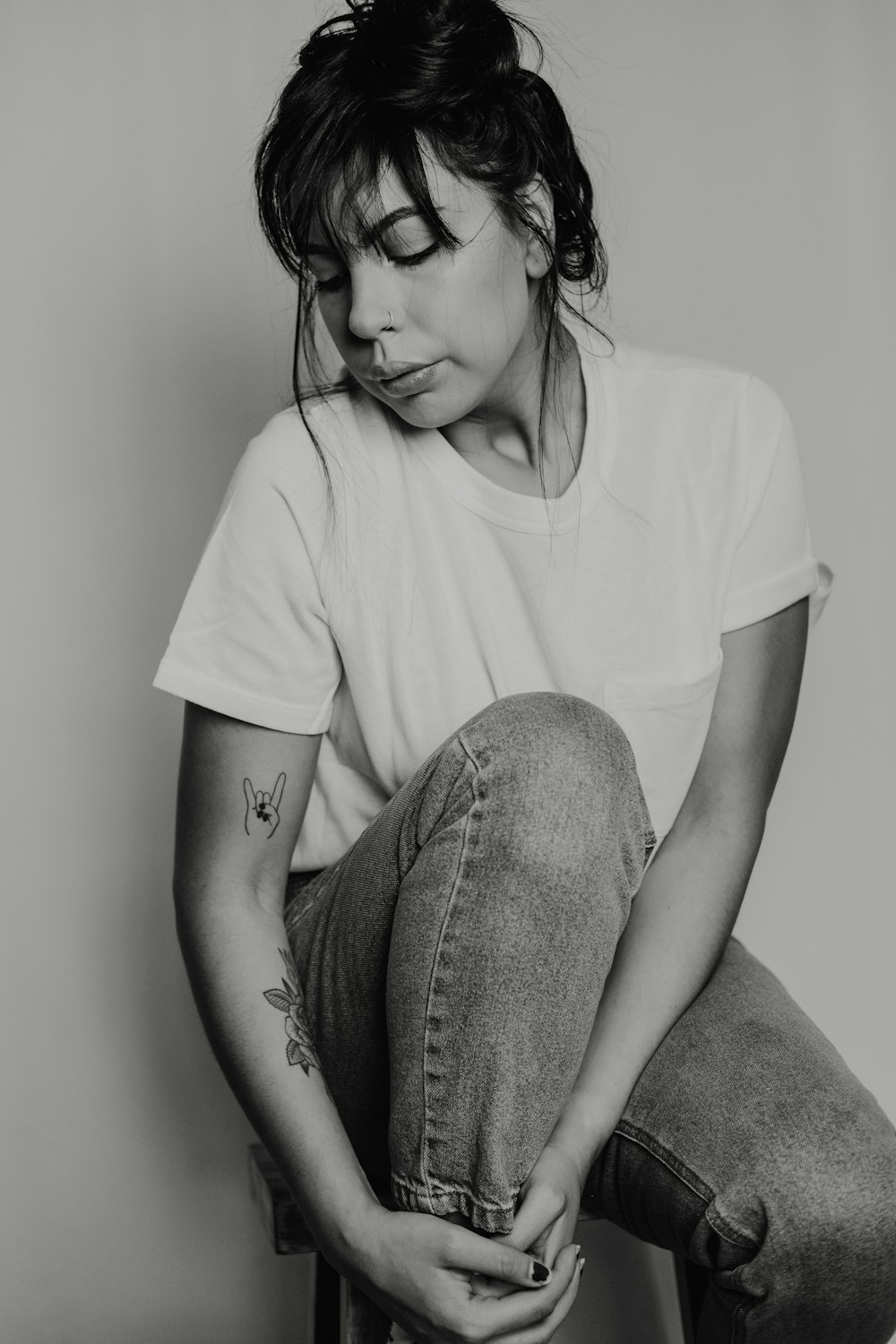 grayscale photo of sitting woman