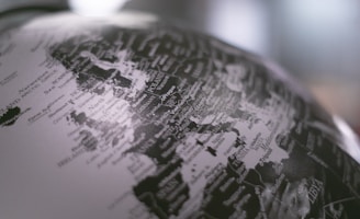 grayscale photo of desk globe