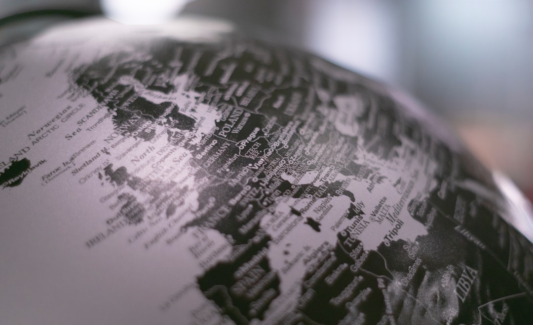 grayscale photo of desk globe,