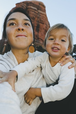 A candid portrait session with a mother and child in natural light outdoors.