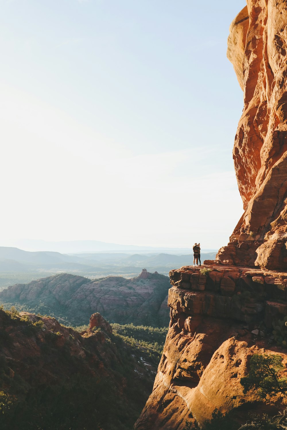 two people standing on canyon during daytime