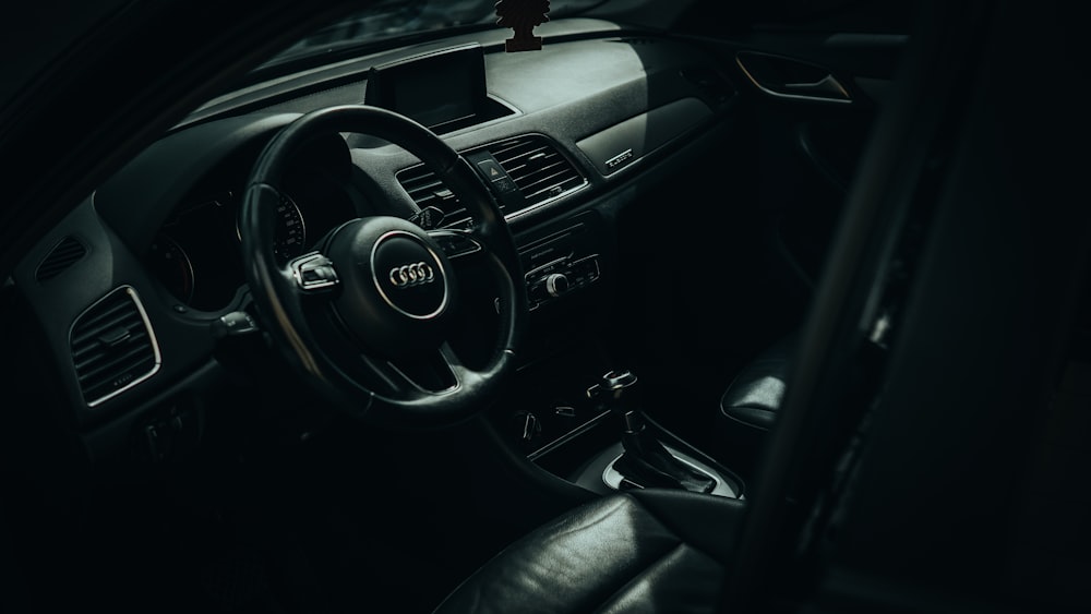 the interior of a car with a steering wheel and dashboard