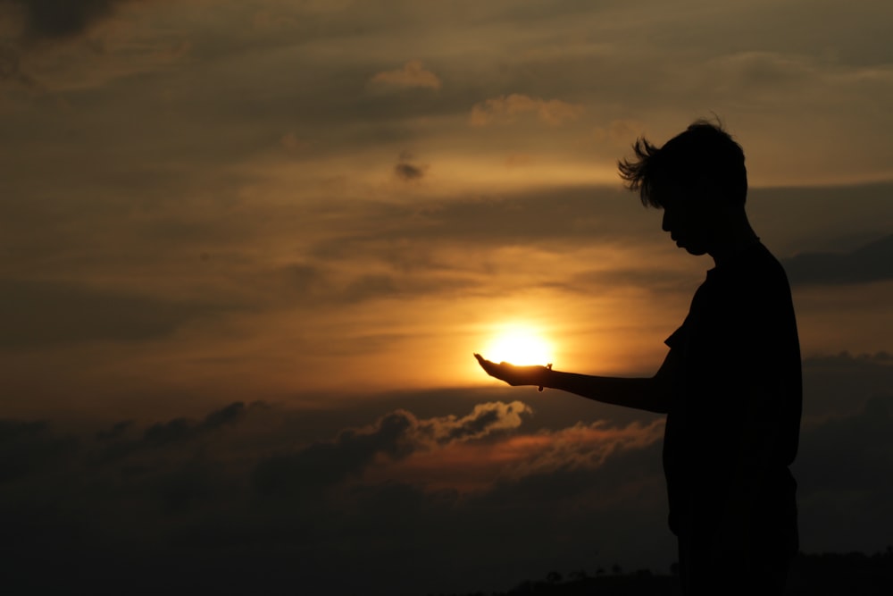 silhouette of man during golden hour