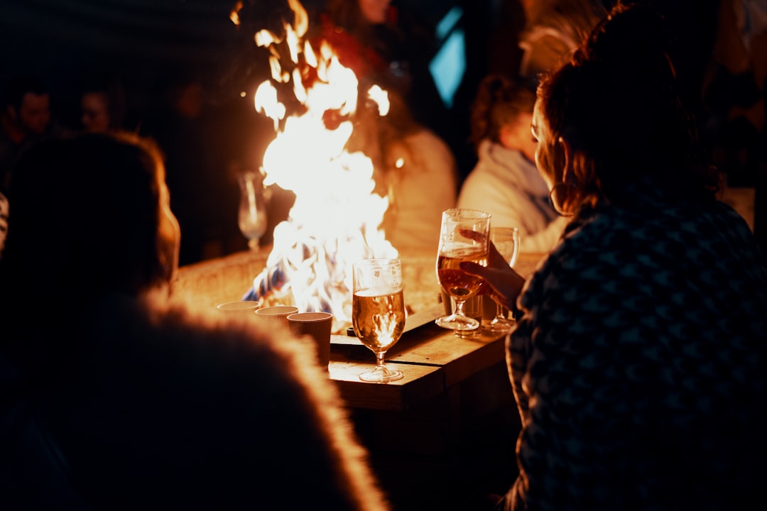 people sitting near bonfire during night time