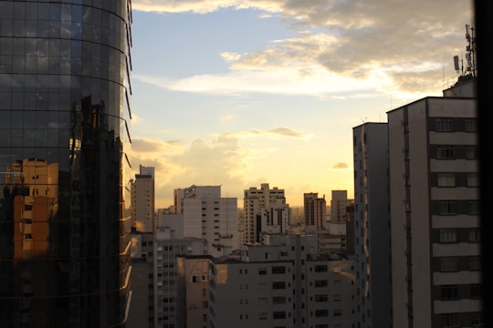 A city skyline showcasing various apartment buildings at sunset.