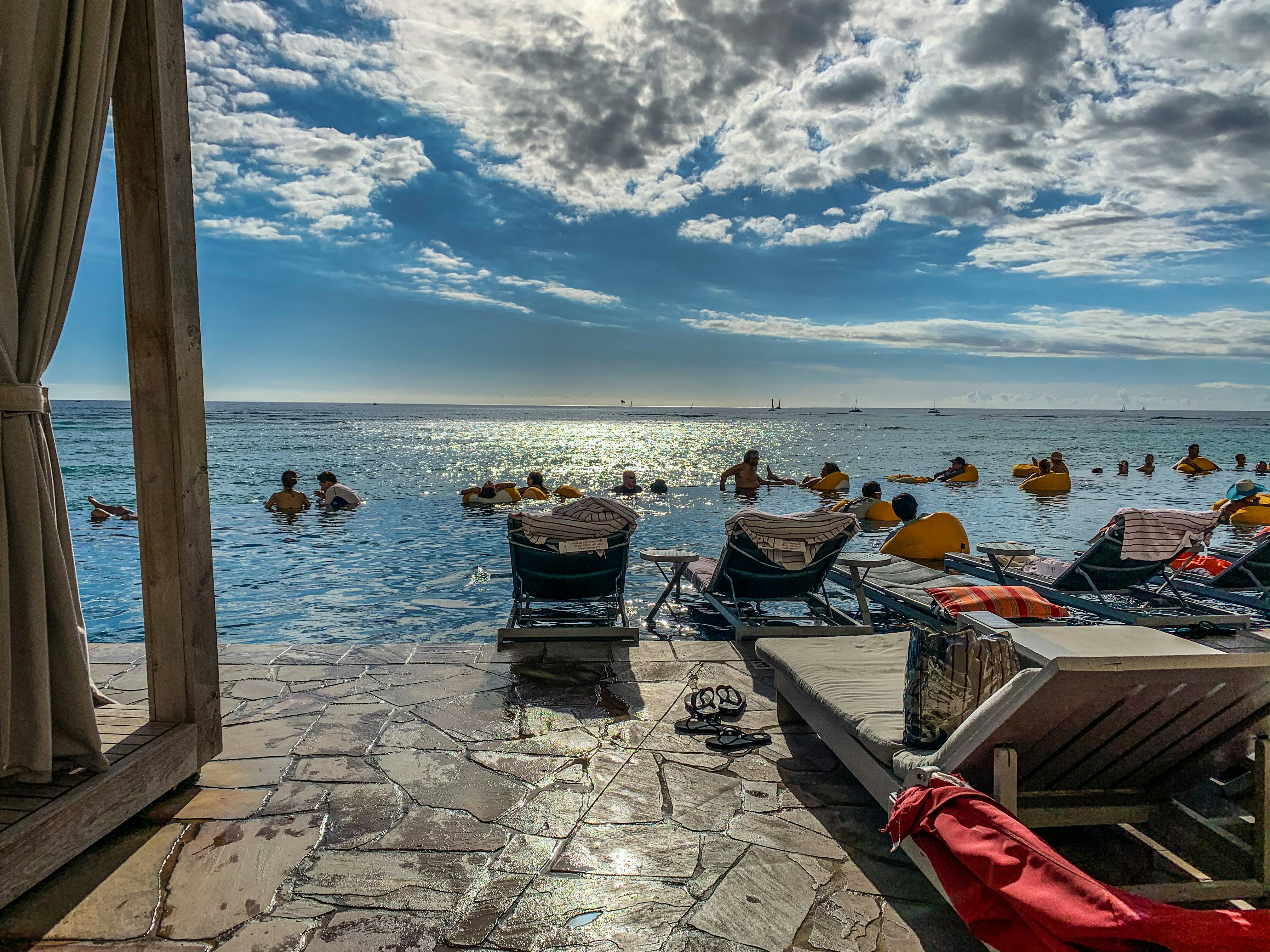 people on beach under white and blue sky
