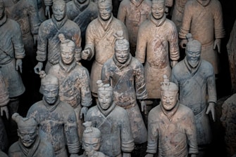 selective focus photography of Terracotta warriors statue lot