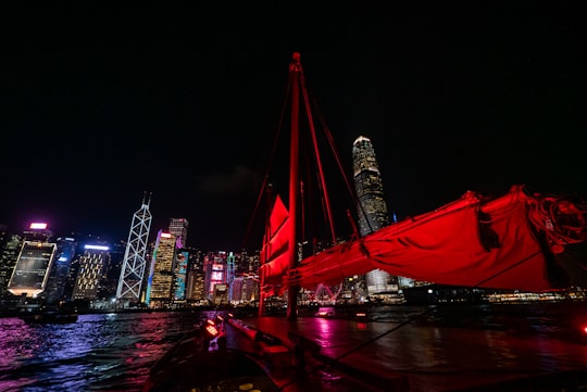 city with high-rise buildings during night time in Victoria Harbour Hong Kong