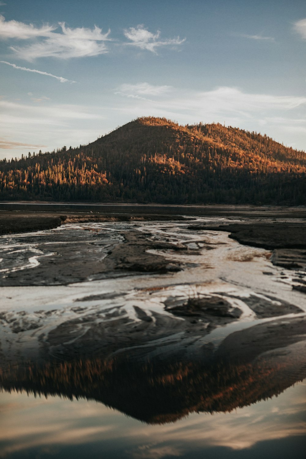 a large body of water with a mountain in the background