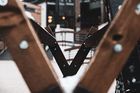 Close-up of skilled carpenter fitting wooden beams in a modern construction site.