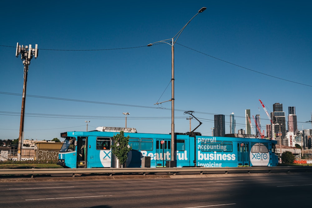 blue tram during daytime