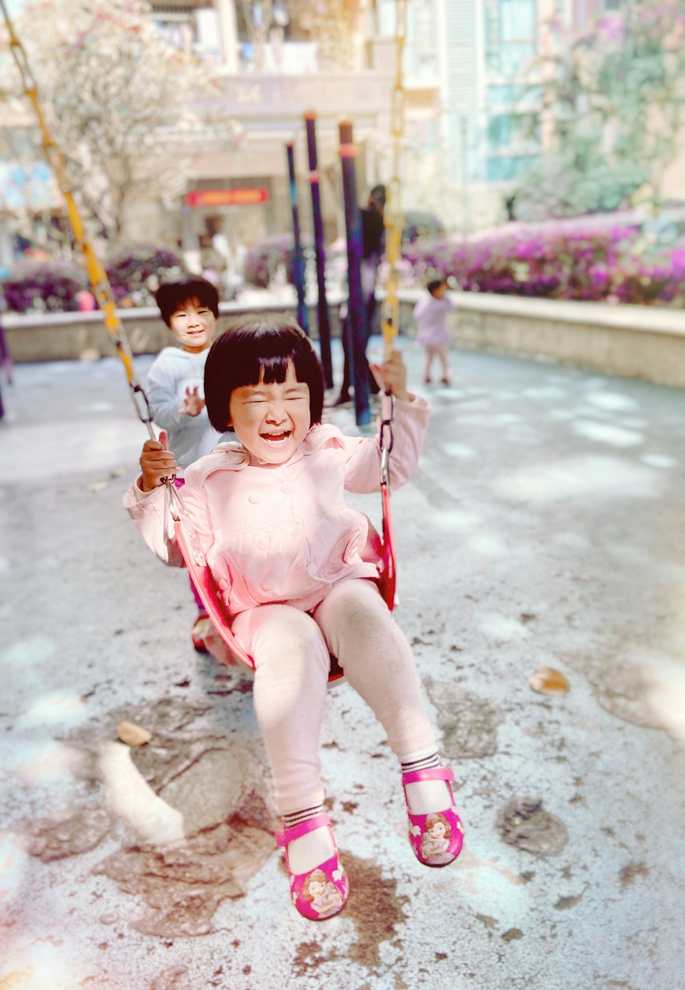 swinging girl by child during daytime