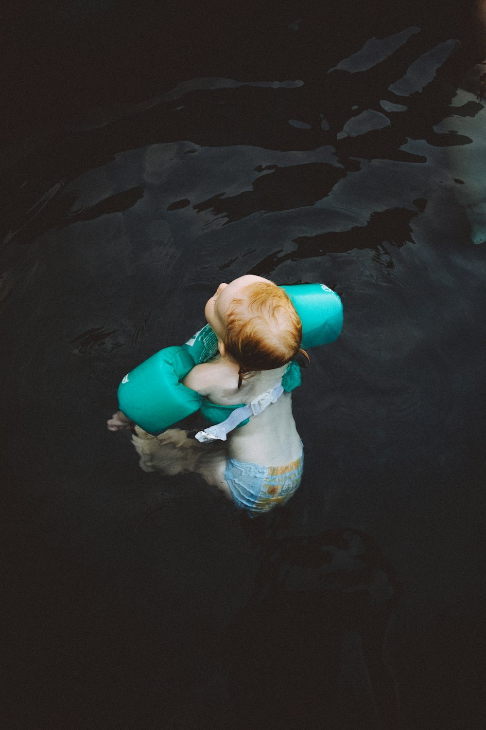 baby wearing blue swimsuit