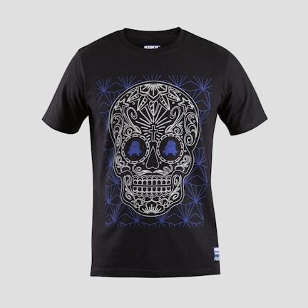 A black T-shirt features an intricate skull design with floral and geometric patterns in white and blue. The skull is stylized with ornate details highlighting the eyes, nose, and mouth, creating a visually striking effect against the dark fabric.
