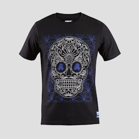 A black T-shirt features an intricate skull design with floral and geometric patterns in white and blue. The skull is stylized with ornate details highlighting the eyes, nose, and mouth, creating a visually striking effect against the dark fabric.