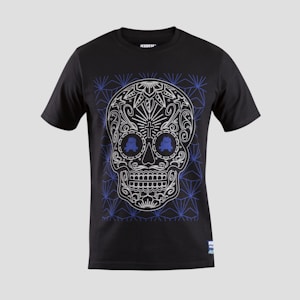 A black T-shirt features an intricate skull design with floral and geometric patterns in white and blue. The skull is stylized with ornate details highlighting the eyes, nose, and mouth, creating a visually striking effect against the dark fabric.