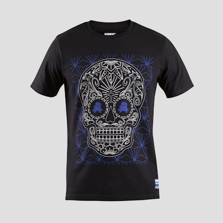 A black T-shirt features an intricate skull design with floral and geometric patterns in white and blue. The skull is stylized with ornate details highlighting the eyes, nose, and mouth, creating a visually striking effect against the dark fabric.