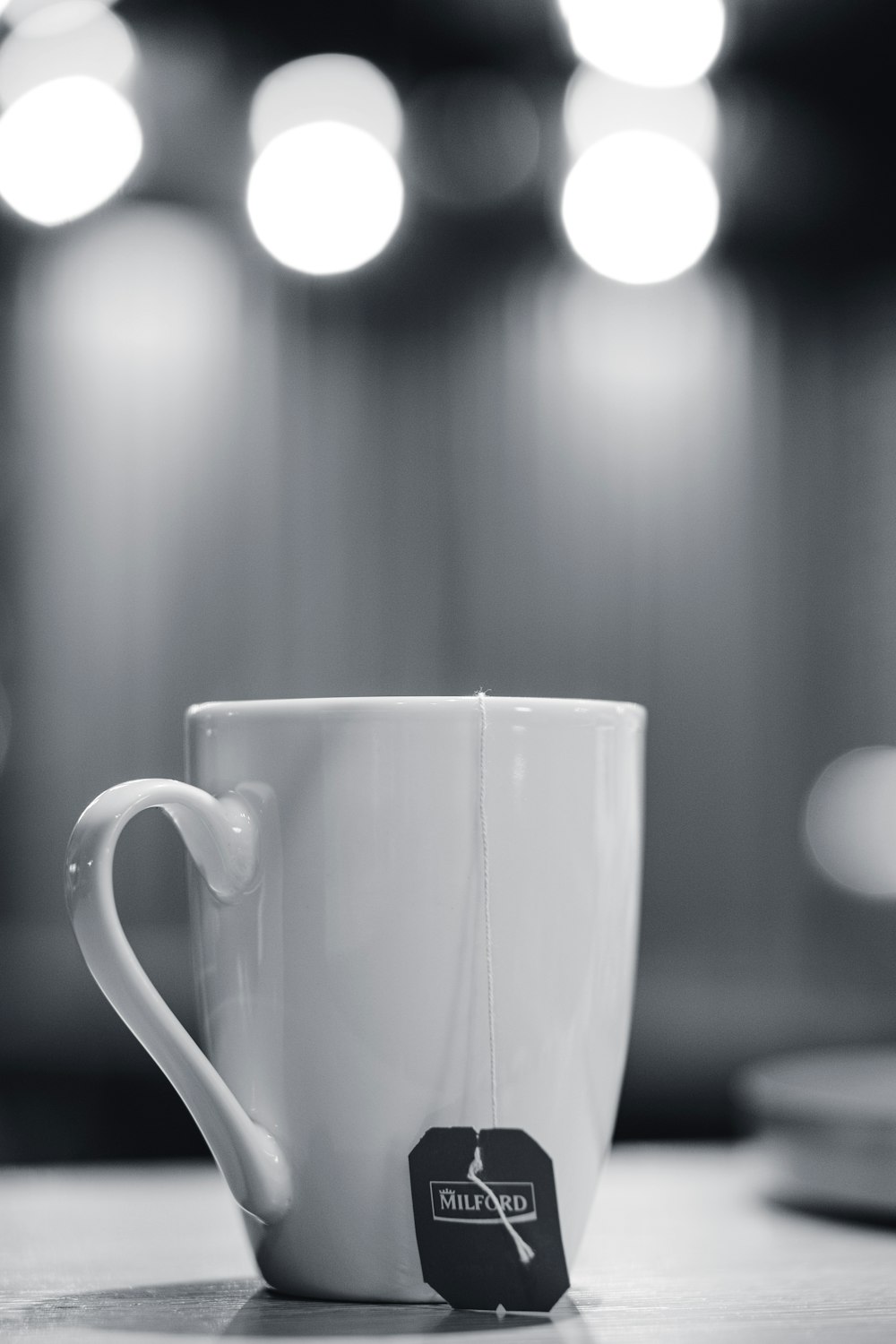 grayscale photography of tea bag tag from mug