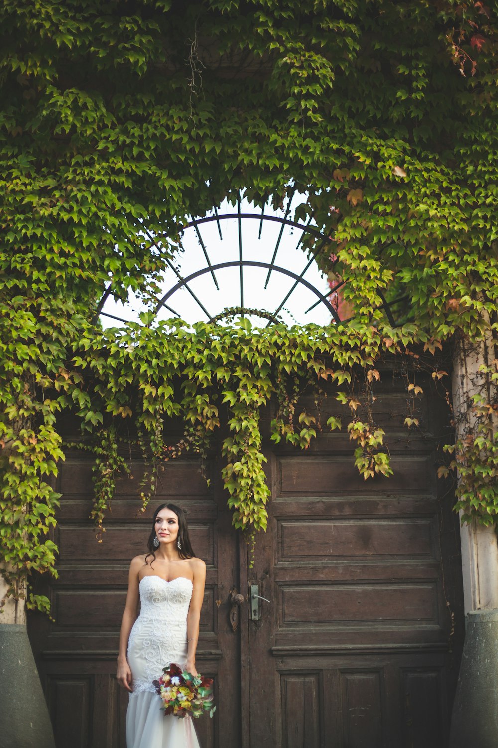 woman in white dress standing by close door