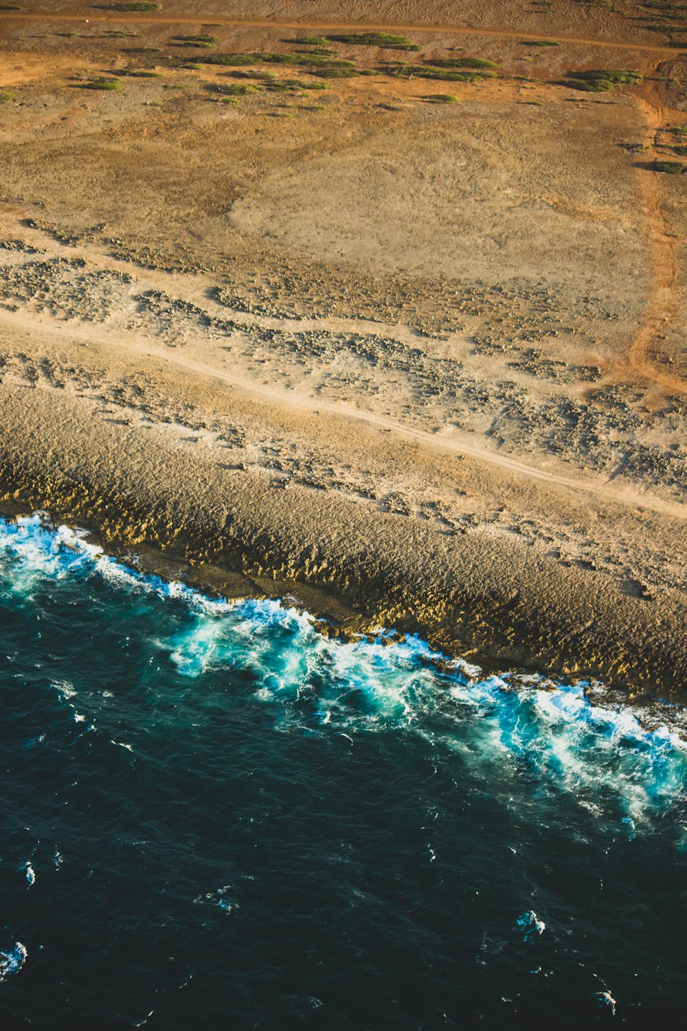 aerial photography of green body of water