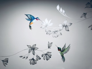 Vibrant color tattoo of a hummingbird in flight on shoulder.