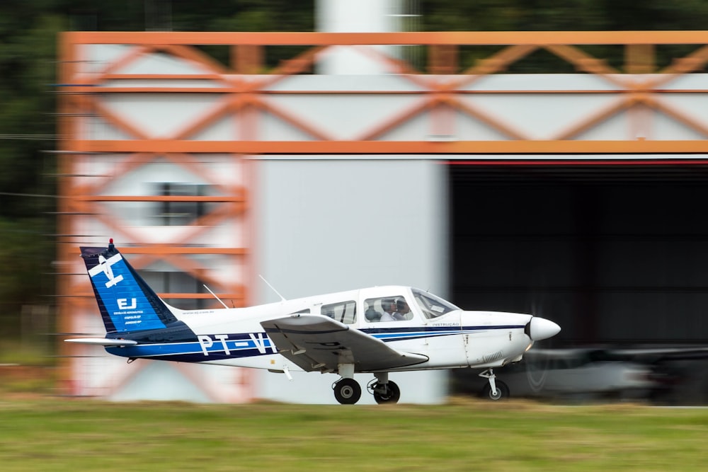 white and blue biplane