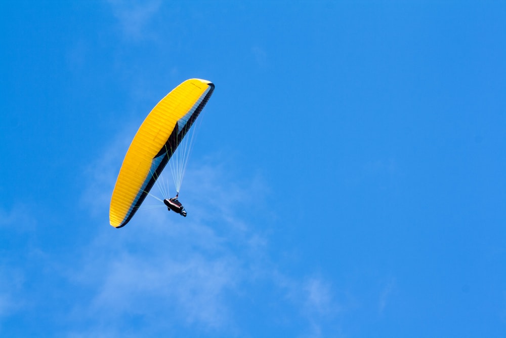 person riding yellow parachute