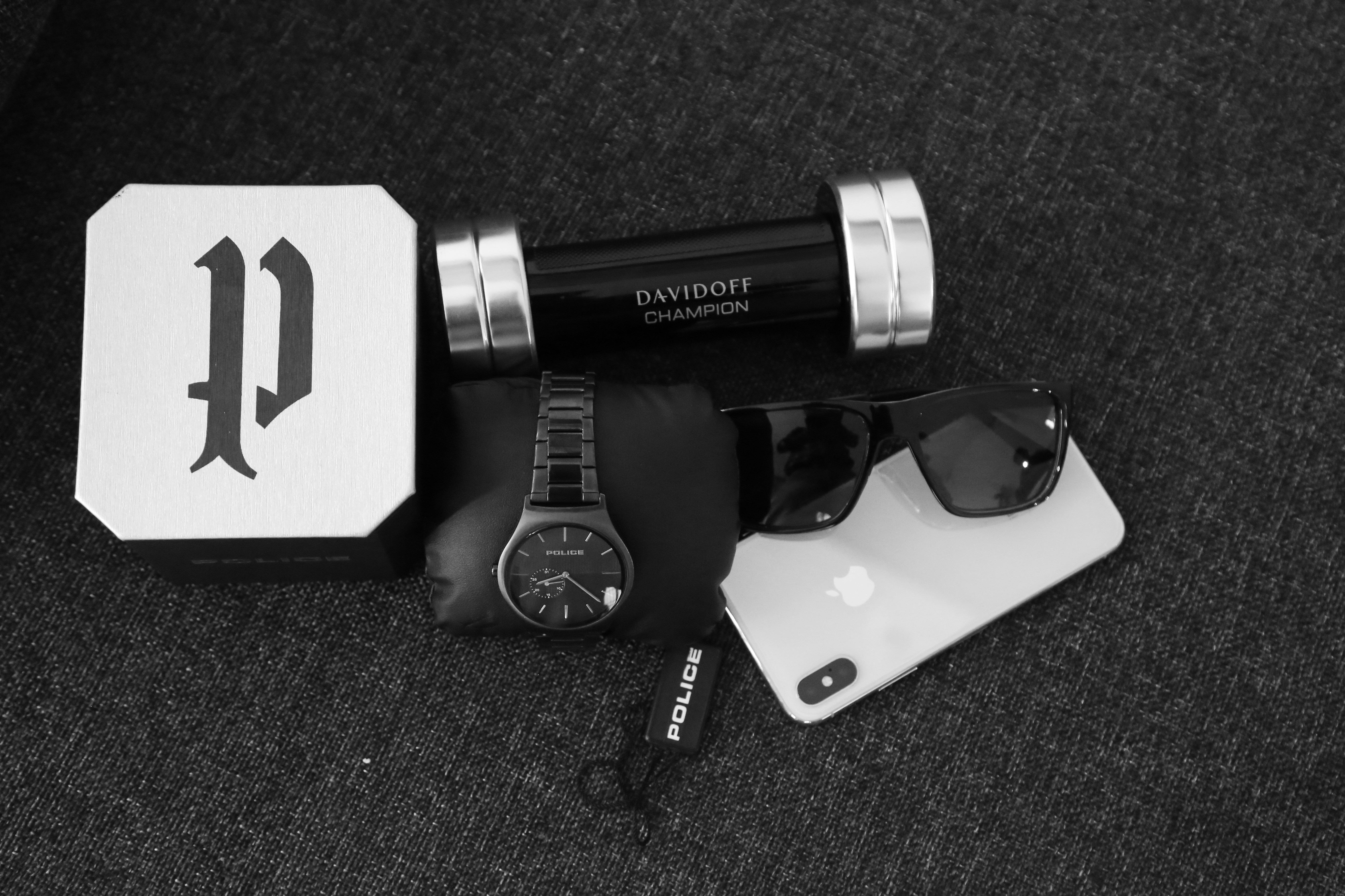 Men grooming products and cologne on dark masculine surface with dramatic side lighting, luxury mens collection photography