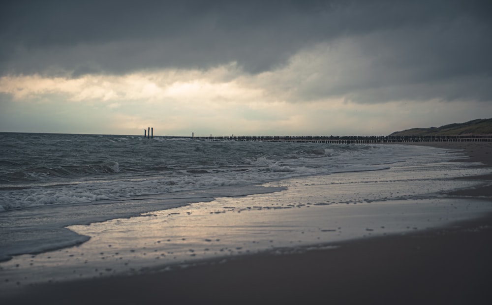 gray body of water under white and gray sky