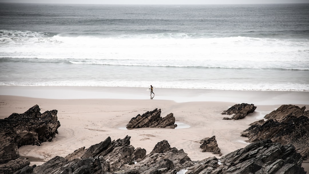 view photography of person in seashore