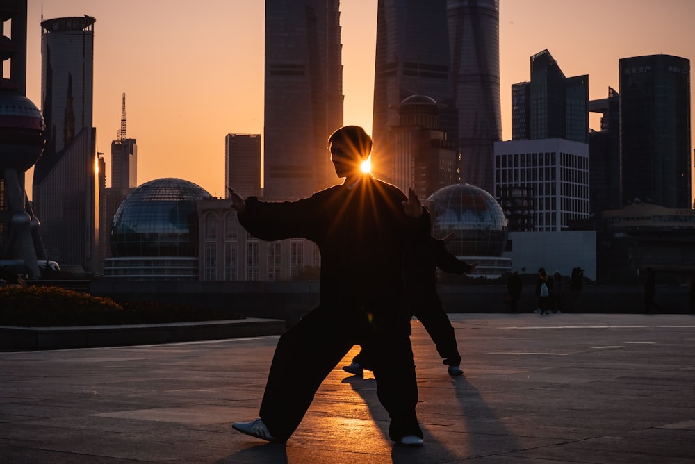 silhouette of man near buildings