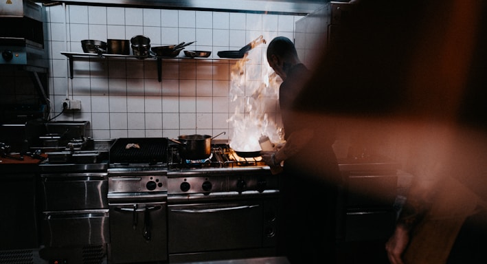 person doing cook inside kitchen