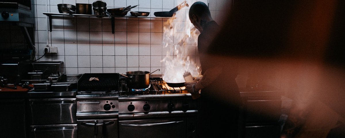 person doing cook inside kitchen