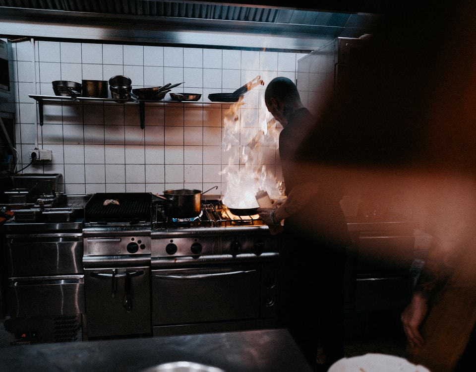 person doing cook inside kitchen